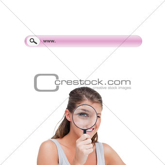 Composite image of woman looking through a magnifying glass