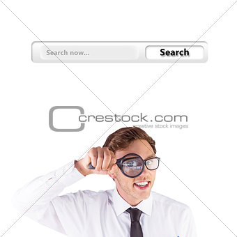 Composite image of geeky businessman looking through magnifying glass