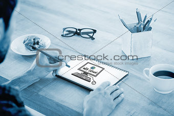 Composite image of creative businessman writing notes on notebook