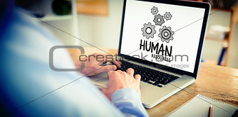 Composite image of businessman working on his laptop