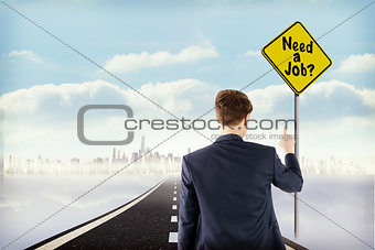 Composite image of businessman pointing something with his finger