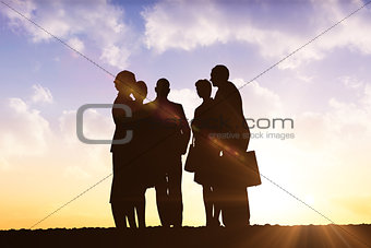 Composite image of silhouettes standing