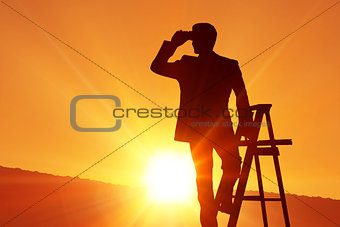 Composite image of silhouette standing on ladder
