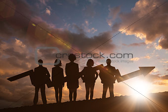 Composite image of business team with arrow