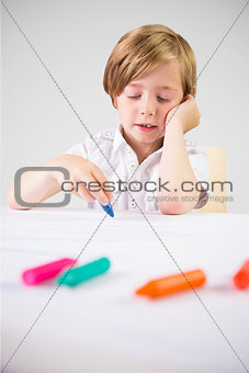 Composite image of cute boy colouring