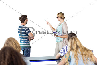 Composite image of student and teacher pointing at blackboard in class