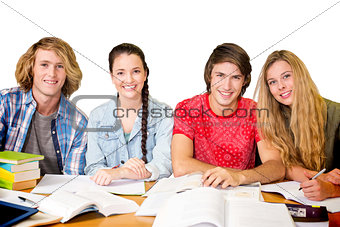 Composite image of college students doing homework in library