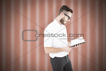 Composite image of geeky young man reading from black book