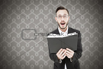 Composite image of young preacher reading from bible