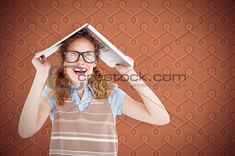 Composite image of geeky hipster woman covering her head with her laptop