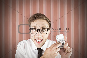 Composite image of geeky businessman using a calculator