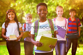 Composite image of smiling little school kids in school corridor