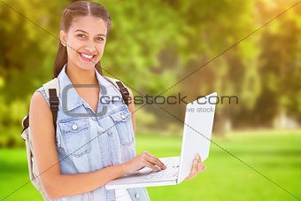 Composite image of student using laptop