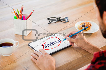 Maximum against creative businessman writing notes on notebook