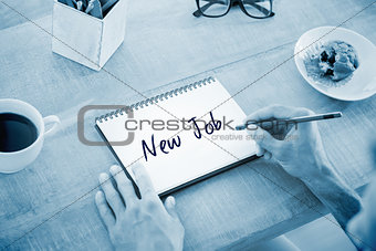 Testing against man writing notes on notebook