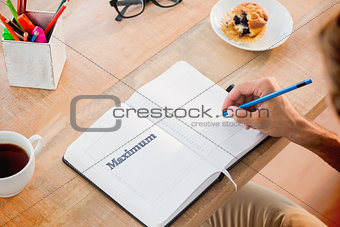 Maximum against man writing notes on diary