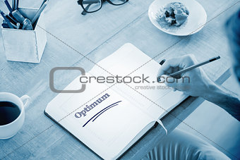 Optimum against man writing notes on diary