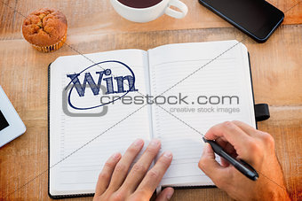 Win against man writing notes on diary
