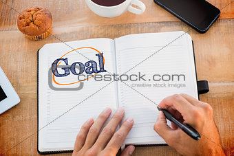 Goal  against man writing notes on diary