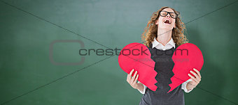 Composite image of geeky hipster holding a broken heart card