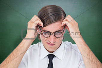 Composite image of furious geeky businessman