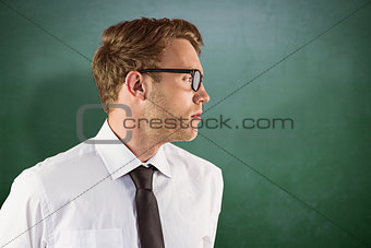 Composite image of young geeky businessman looking away