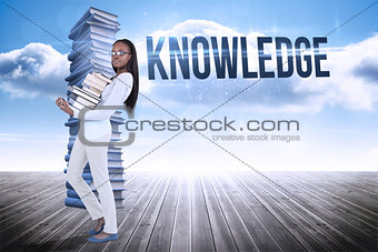 Knowledge against stack of books against sky