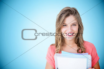 Composite image of smiling hipster holding notebook