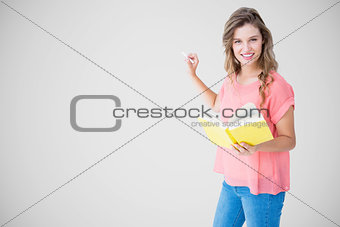 Composite image of hipster woman holding book
