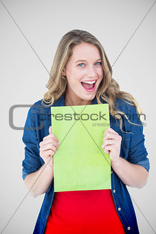 Composite image of smiling student holding notebook