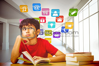 Composite image of thoughtful boy reading book in library
