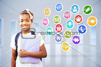 Composite image of little girl holding folders in school corridor