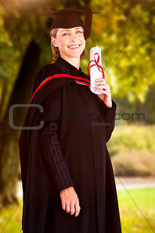 Composite image of confident graduated woman looking at the camera