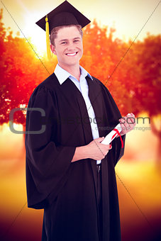 Composite image of a smiling man looking at the camera as he graduates