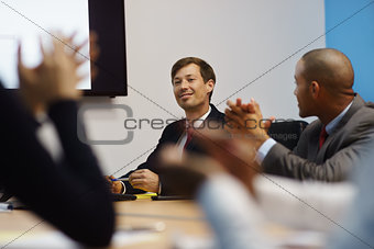 Business Man Doing Presentation And People Applauding In Meeting