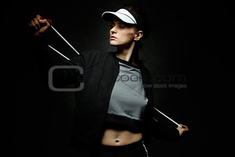 Woman athlete workout with resistance band on black background
