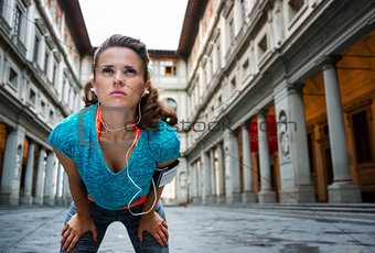 Sporty woman catching breath in front of Uffizi gallery