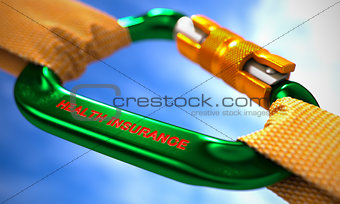 Health Insurance on Green Carabiner between Orange Ropes.