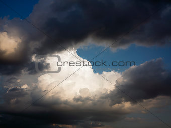 Dark and white clouds and blue sky