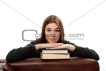 Young woman leaning on books