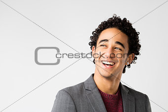 elegant young man with curly hair laughing 
