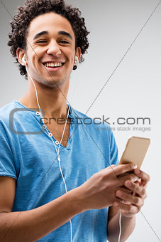 happy young man holding a smartphone
