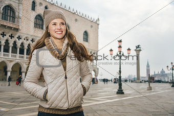 Smiling woman tourist standing on St. Mark's Square, Venice