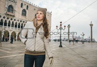 Woman tourist standing on St. Mark's Square near Dogi Palace