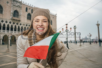 Woman tourist with Italian flag standing on St. Mark's Square
