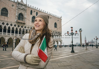 Woman tourist with Italian flag standing near Dogi Palace