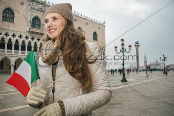 Woman tourist with Italian flag standing on St. Mark's Square