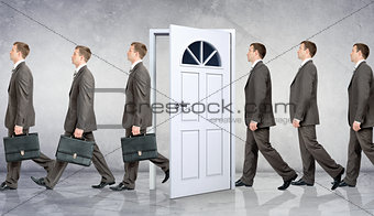 Line of businessmen going through door