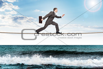 Businessman running on rope