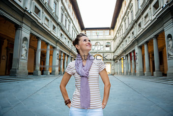 Happy young woman tourist having a walk tour in Florence, Italy